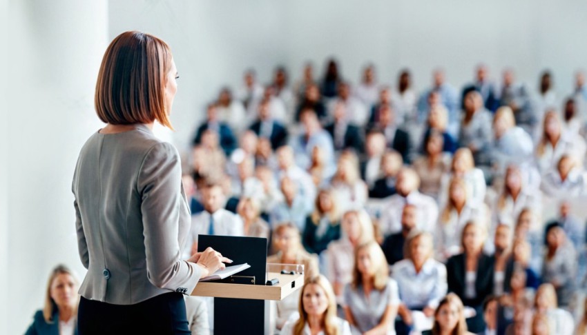 Female speaker giving a talk on corporate business conference